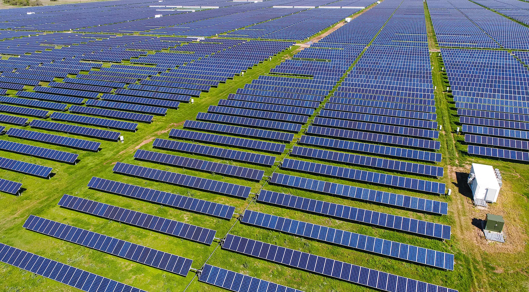 Solar farm aerial view with grid-scale photovoltaic arrays