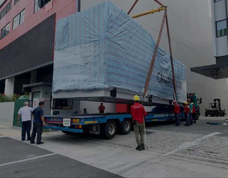 FlexEstack module rigged for lift — wrapped for transport during on-site installation.