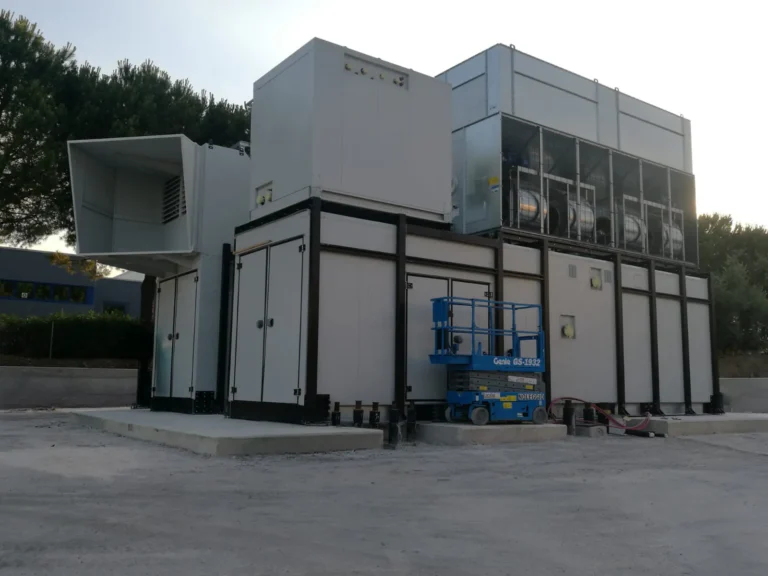 FlexEgen gas CHP package — combined heat and power module with rooftop dry cooler, side attenuator wall and acoustic enclosure for low-emission on-site generation.
